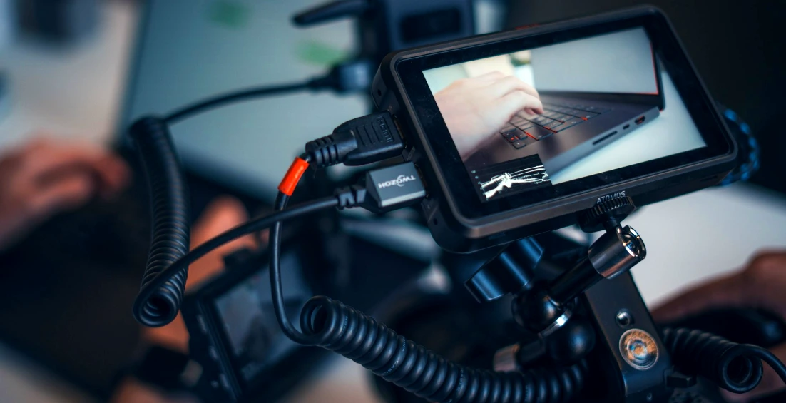 Camera monitor showing a laptop and cables